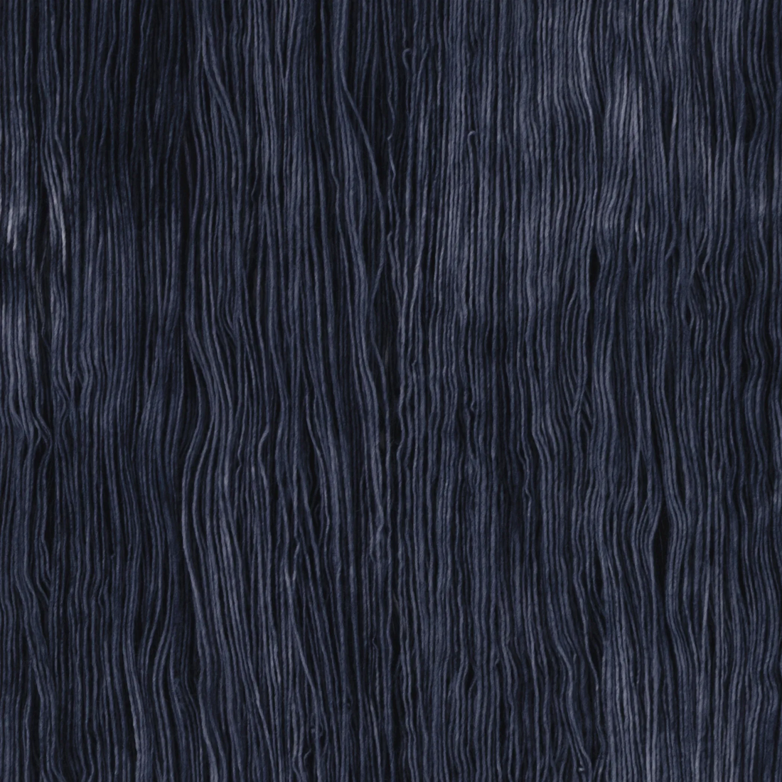 Sysleriget hand dyed yarn in single ply merino wool in the color Storm Blue.